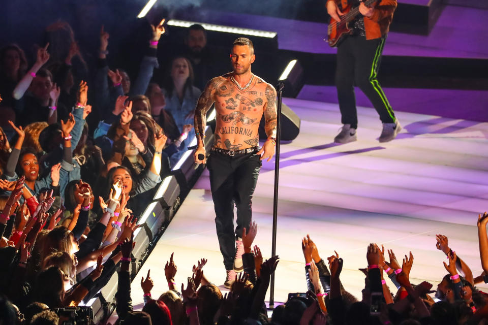 Adam Levine showcasing his many tattoos during his Super Bowl performance. [Photo: Getty]