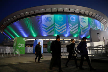 People walk in front of the venue of the COP24 U.N. Climate Change Conference 2018 in Katowice, Poland December 5, 2018. REUTERS/Kacper Pempel