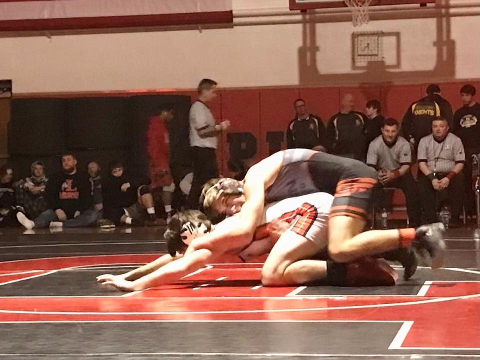 Elgin's Quinten Harrison, top, competes in last year's finals of the Sally George Wrestling Invitational last season at Pleasant.