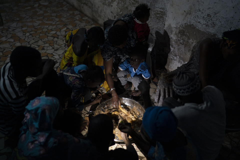 Ndeye Yacine Dieng breaks the fast with her family during the holy month of Ramadan at her home in Bargny, Senegal some 35 kilometers (22 miles) east of Dakar, Senegal, Wednesday April 21, 2021. (AP Photo/Leo Correa)