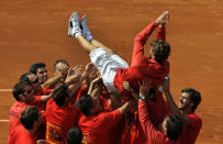 Juan Carlos Ferrero of Spain celebrates with his team mates after their victory over the U.S. at the Davis Cup semi-final at the Parque Hermanos Castro in Gijon, northern Spain September 16, 2012. REUTERS/Eloy Alonso (SPAIN - Tags: SPORT TENNIS)