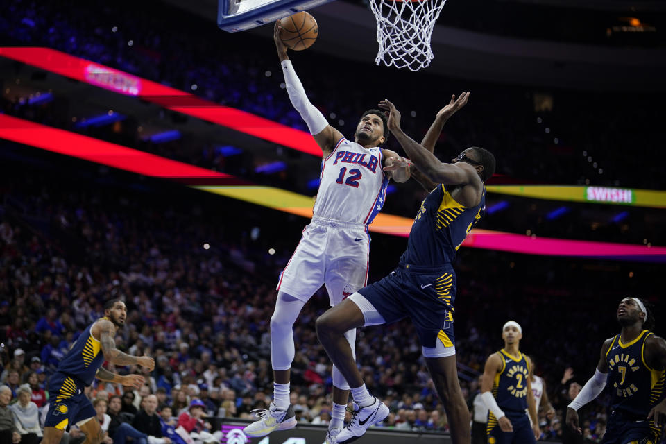 Philadelphia 76ers' Tobias Harris, left, goes up for a shot past Indiana Pacers' Jalen Smith during the first half of an NBA basketball game, Sunday, Nov. 12, 2023, in Philadelphia. (AP Photo/Matt Slocum)