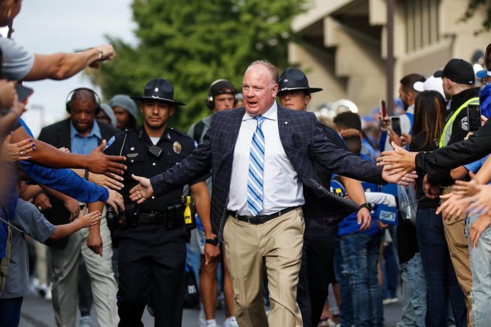 Kentucky head coach Mark Stoops interacts with fans during the Cat Walk ahead of his team’s game against Northern Illinois on Saturday, Sept. 24, 2022, at Kroger Field in Lexington, Ky.