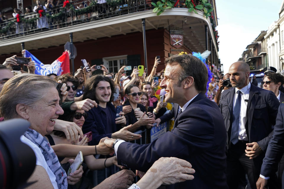 French President Emmanuel Macron greets the crowd in New Orleans, Friday, Dec. 2, 2022. (AP Photo/Gerald Herbert)