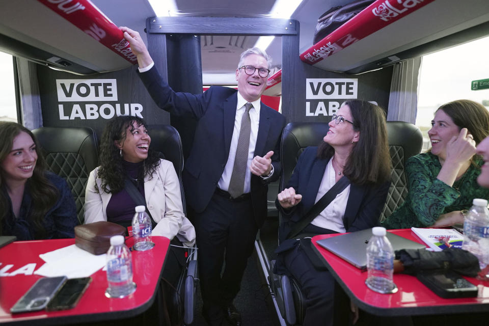 Britain's Labour Party leader Sir Keir Starmer talks to journalists on the Labour battle bus while on the General Election campaign trail, Thursday June 13, 2024. (Stefan Rousseau/PA via AP)
