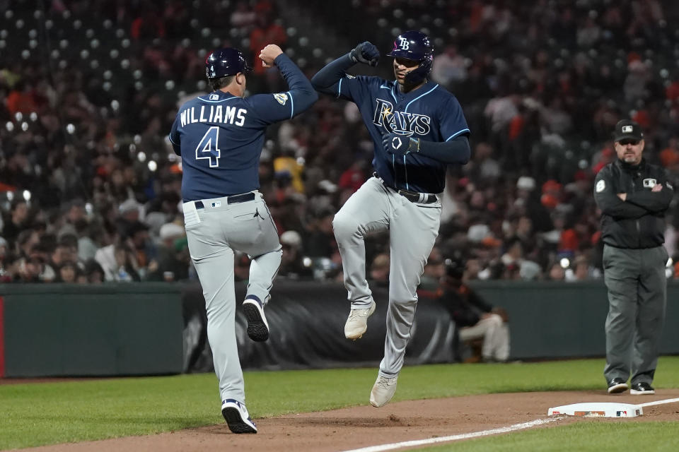 Tampa Bay Rays' Christian Bethancourt, right, is congratulated by third base coach Brady Williams (4) after hitting a home run against the San Francisco Giants during the seventh inning of a baseball game in San Francisco, Monday, Aug. 14, 2023. (AP Photo/Jeff Chiu)