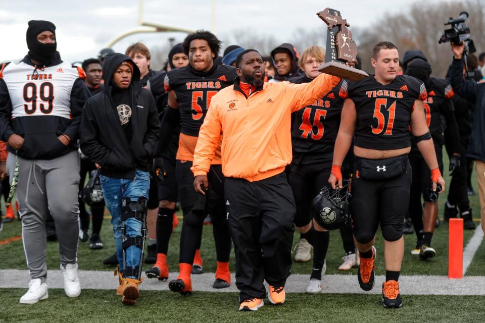 Belleville head coach Jermain Crowell and players celebrates 12-7 win over Dearborn Fordson at Belleville High School in Belleville on Saturday, Nov. 13, 2021.