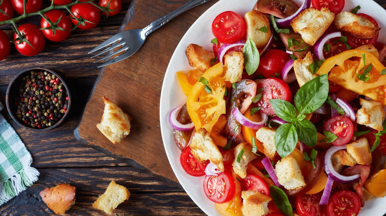 Bread and tomato salad on white plate