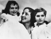 <p>A 2-year-old Elizabeth Taylor smiles with her mother, actress Sara Sothern, and her brother, Howard. She was born in 1932 in an area known as London's Hampstead Garden Suburb, where she lived in Heathwood, her Georgian-style childhood home, until 1939. </p>