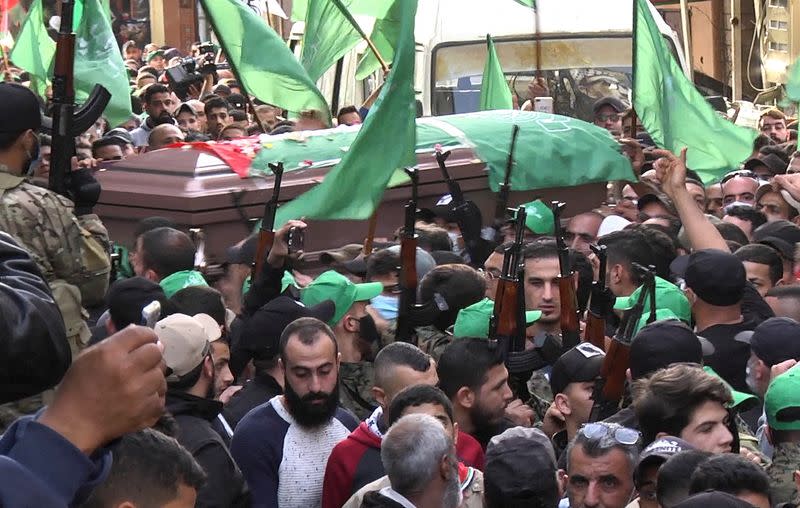 Members of Palestinian group Hamas carry their weapons during a funeral in Tyre