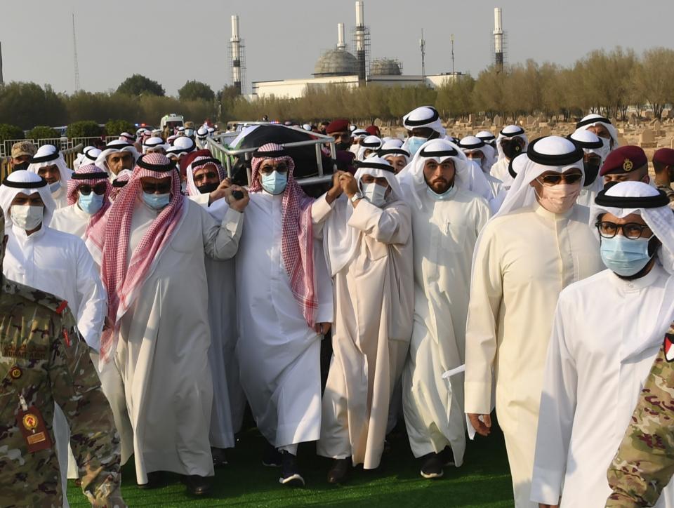 In this photo released by Diwan Al Amiri, the body of the late Emir of Kuwait Sheikh Sabah Al Ahmad Al Sabah is carried during his funeral ceremony in Kuwait, Wednesday, Sept. 30, 2020. The late Emir drew on his decades as the oil-rich nation’s top diplomat to push for closer ties to Iraq after the 1990 Gulf War and solutions to other regional crises, died Tuesday, Sept. 29, 2020. He was 91. (Diwan Al Amiri via AP)