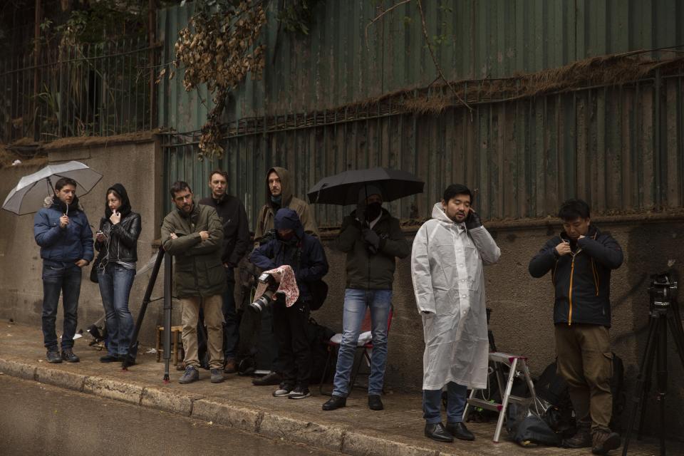 Journalists stake out the house of ex-Nissan chief Carlos Ghosn in Beirut, Lebanon, Friday, Jan. 3, 2020. The former Nissan Motor Co. Chairman fled Japan this week while awaiting trial on financial misconduct charges and appeared in Lebanon. (AP Photo/Maya Alleruzzo)