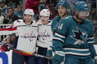 Washington Capitals right wing Nicolas Aube-Kubel is congratulated by center Nic Dowd after scoring against the San Jose Sharks during the second period of an NHL hockey game in San Jose, Calif., Saturday, March 4, 2023. (AP Photo/Jeff Chiu)