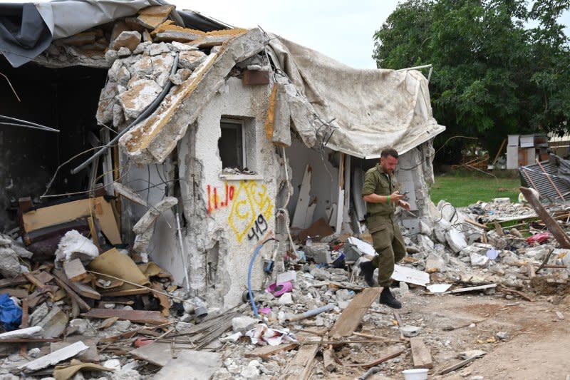 A Israeli soldier inspects a house of a young family that was attacked in the Hamas terrorists attack on October 7 in Kibbutz Kfar Aza near the Gaza border on Friday. Photo by Debbie Hill/ UPI