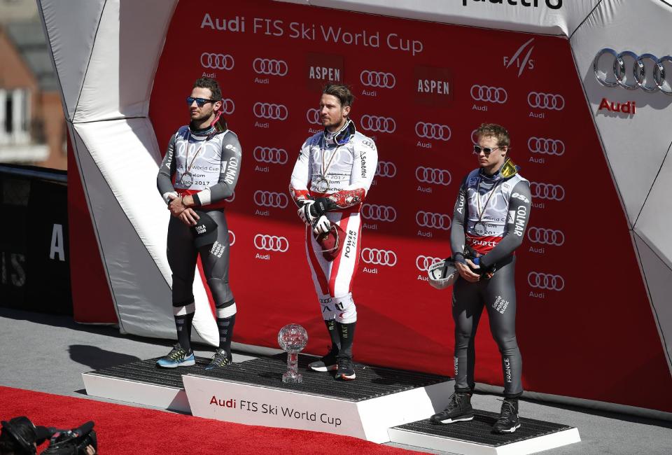 World Cup men's giant slalom overall champion Austria's Marcel Hirscher, center, stands on the podium with second place overall finisher France's Mathieu Faivre, left, and third place overall finisher France's Alexis Pinturault after a men's World Cup giant slalom ski race Saturday, March 18, 2017, in Aspen, Colo. (AP Photo/Brennan Linsley)