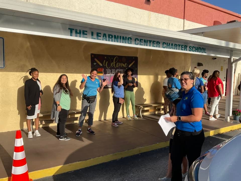 Teachers from The Learning Center welcome students in their first back-to-school day at the new Royal Palm Beach campus.