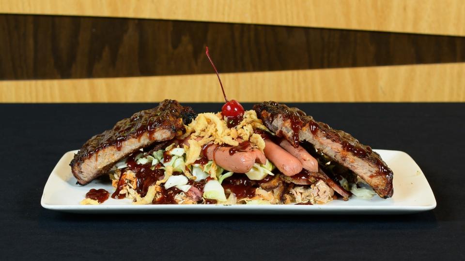 Emmett’s The Pit Boss is a combination of pulled chicken, smoked brisket, two hot dogs and a quarter rack of ribs served over coleslaw with a cherry on top.