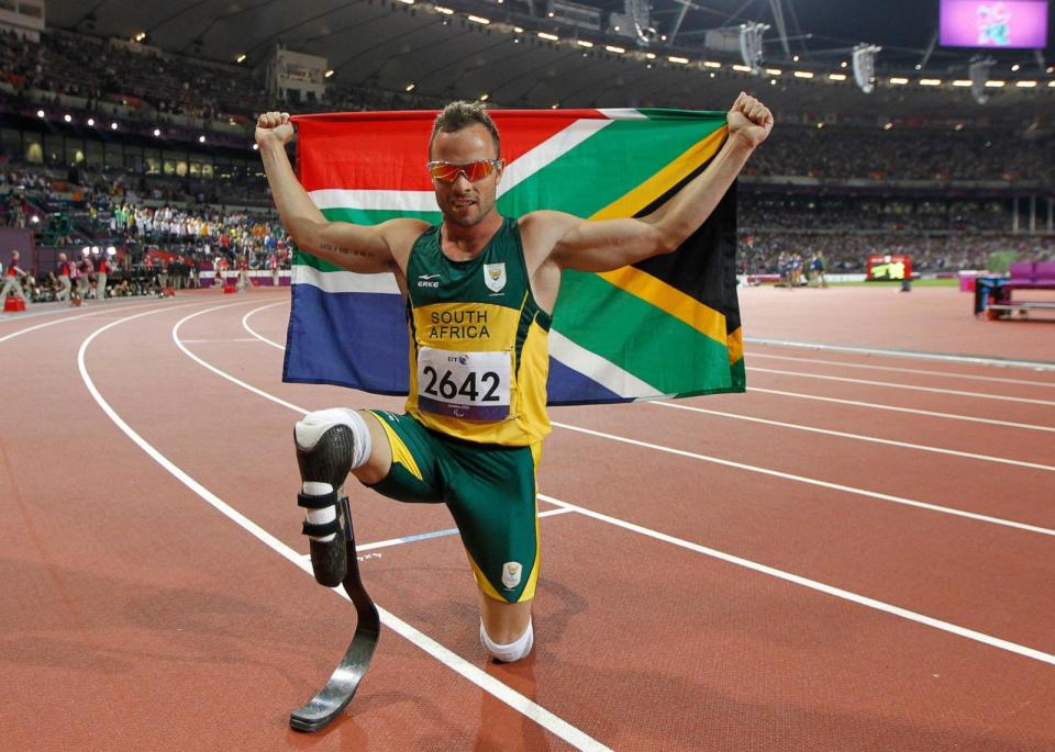 PHOTO: South Africa's Oscar Pistorius poses with photographs with a national flag after winning gold in the men's 400m - T44 final during the athletics competition at the London 2012 Paralympic Games at the Olympic Stadium in London on Sept. 8, 2012. (Ian Kington/AFP via Getty Images, FILE)