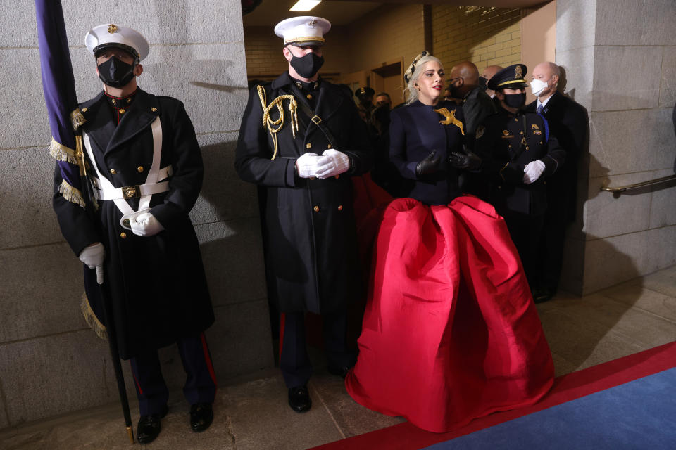 WASHINGTON, DC - JANUARY 20: Lady Gaga with Marine escort Capt. Evan Campbell to sing the National Anthem at the inauguration of U.S. President-elect Joe Biden on the West Front of the U.S. Capitol on January 20, 2021 in Washington, DC. During today's inauguration ceremony Joe Biden becomes the 46th president of the United States. (Photo by Win McNamee/Getty Images)