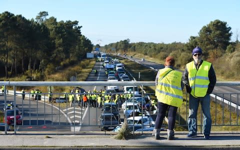 People block the A63 highway during a demonstration of "yellow vests" - Credit: NICOLAS TUCAT/AFP/Getty Images