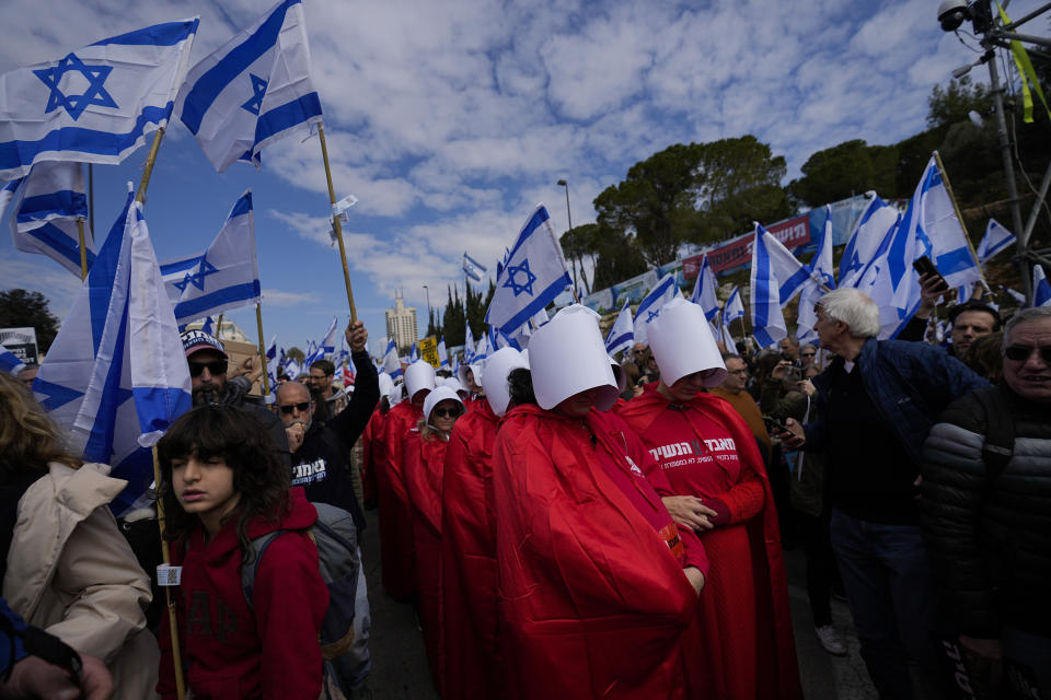 FILE - Israelis protest against plans by Prime Minister Benjamin Netanyahu's new government to overhaul the judicial system, outside the Knesset, Israel's parliament, in Jerusalem, Monday, Feb. 13, 2023. (AP Photo/Ohad Zwigenberg, File)