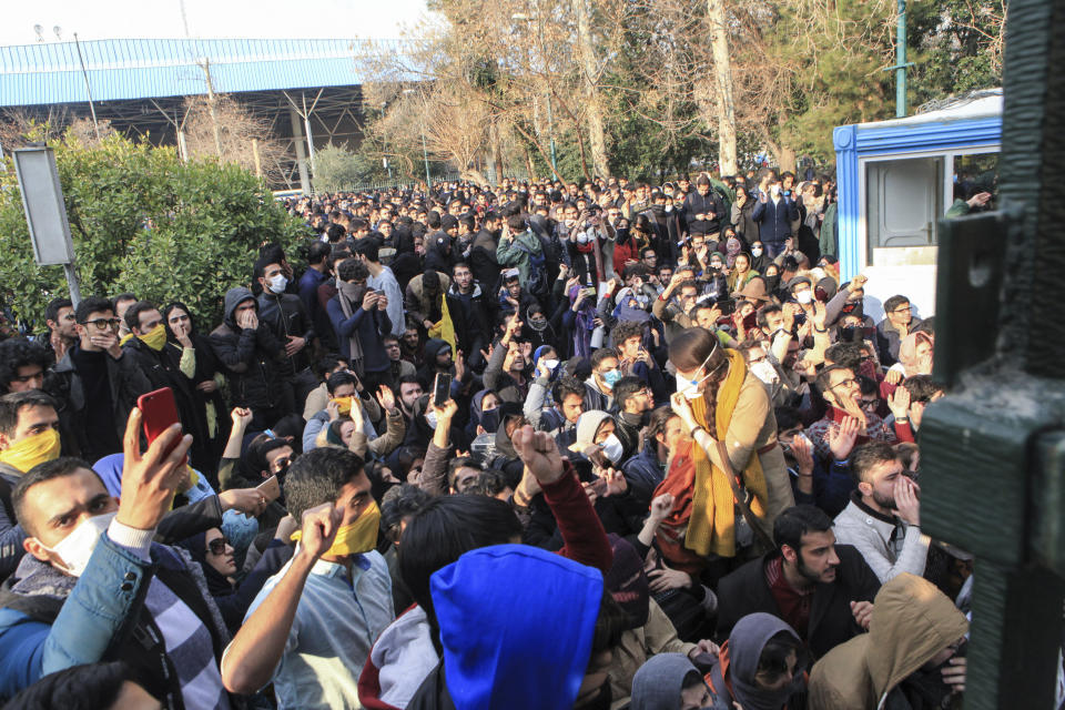 FILE - In this Dec. 30, 2017 file photo taken by an individual not employed by the Associated Press and obtained by the AP outside Iran, university students attend a protest inside Tehran University while anti-riot Iranian police prevent them to join other protestors, in Tehran, Iran. On Tuesday, June 30, 2020, Judiciary spokesman Gholamhossein Esmaili said Iran sentenced journalist Ruhollah Zam to death. Zam whose online work helped inspire the 2017 economic protests had run a website called AmadNews that posted embarrassing videos and information about Iranian officials. He had been living and working in exile in Paris before being convinced into returning to Iran, where he was arrested in October 2019. (AP Photo, File)