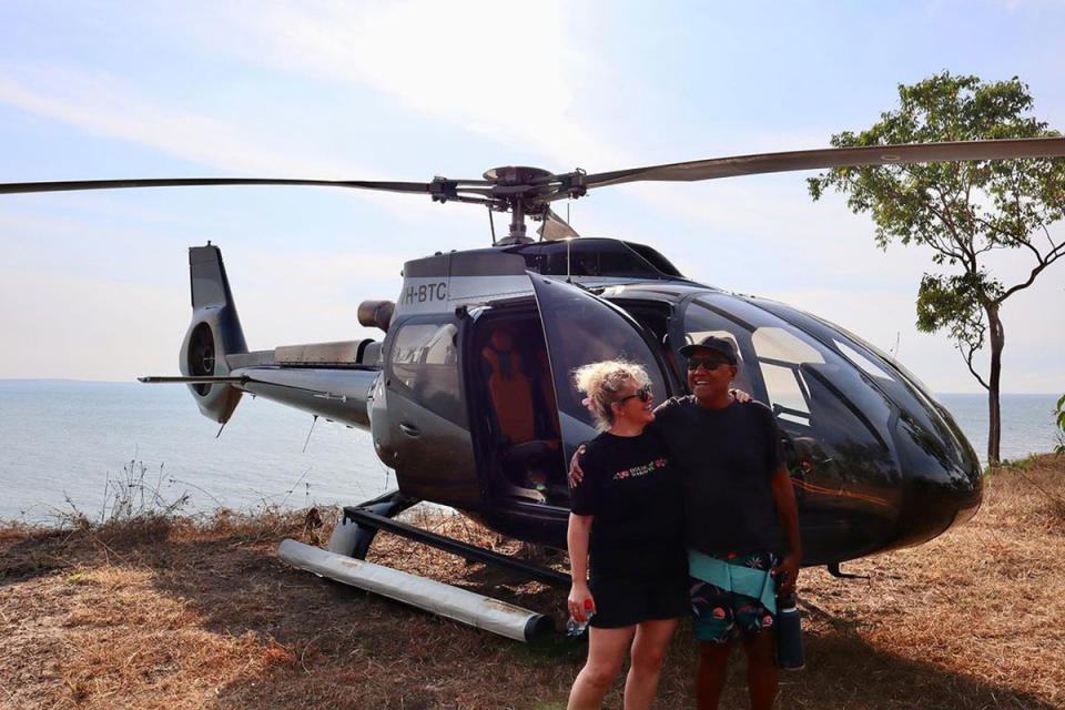 Uncle Robbie and Cath from MasterChef in the Norther Territory standing in front of a helicopter