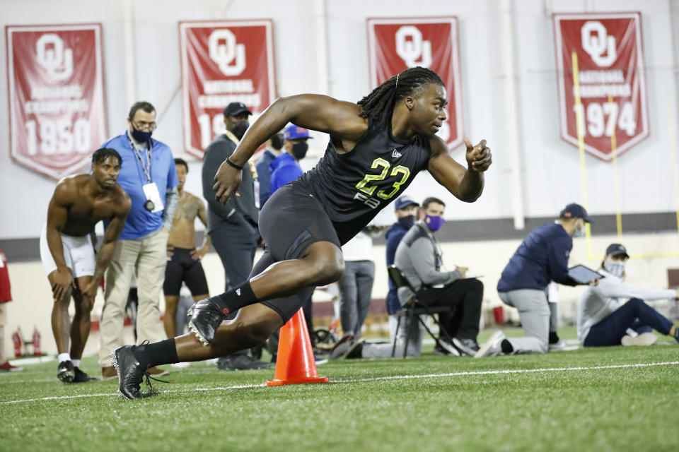 FILE - Oklahoma running back Rhamondre Stevenson participates in the school's Pro Day football workout for NFL scouts in Norman, Okla., in this Friday, March 12, 2021, file photo. The coronavirus pandemic scuttled the annual NFL scouting combine in Indianapolis, leaving prospects to show off for scouts, coaches and general managers at their college pro day instead. While players lamented the lost opportunity to gather in Indy to be poked, prodded, timed and tested — and to square off against their peers — an invitation was still a golden ticket. (AP Photo/Alonzo Adams, FILE)