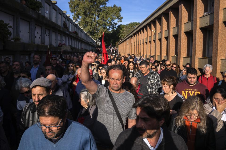 People attend the burial service of Amelia Sanjurjo at La Teja cemetery in Montevideo, Uruguay, Thursday, June 6, 2024. The Uruguayan Prosecutor’s Office confirmed that the human remains found in June 2023 at the 14th Battalion of the Uruguayan Army belong to Sanjurjo, a victim of the 1973-1985 dictatorship who was 41 years old and pregnant at the time of her disappearance. (AP Photo/Matilde Campodonico)