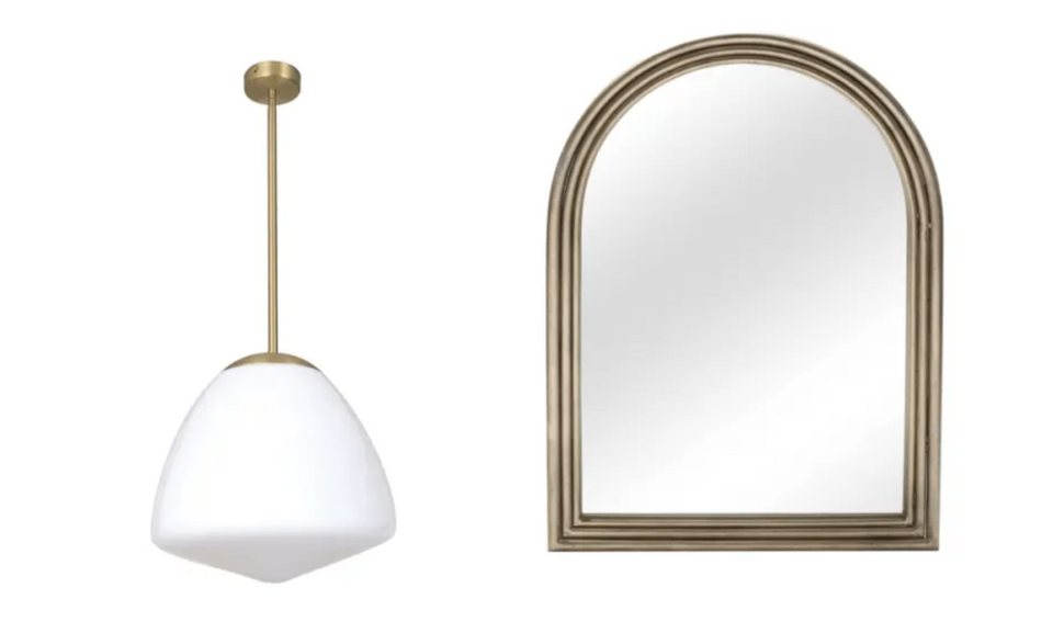 A bronze pendant light with large white fitting sits next an arched mirror with gold frame, both on a white background.
