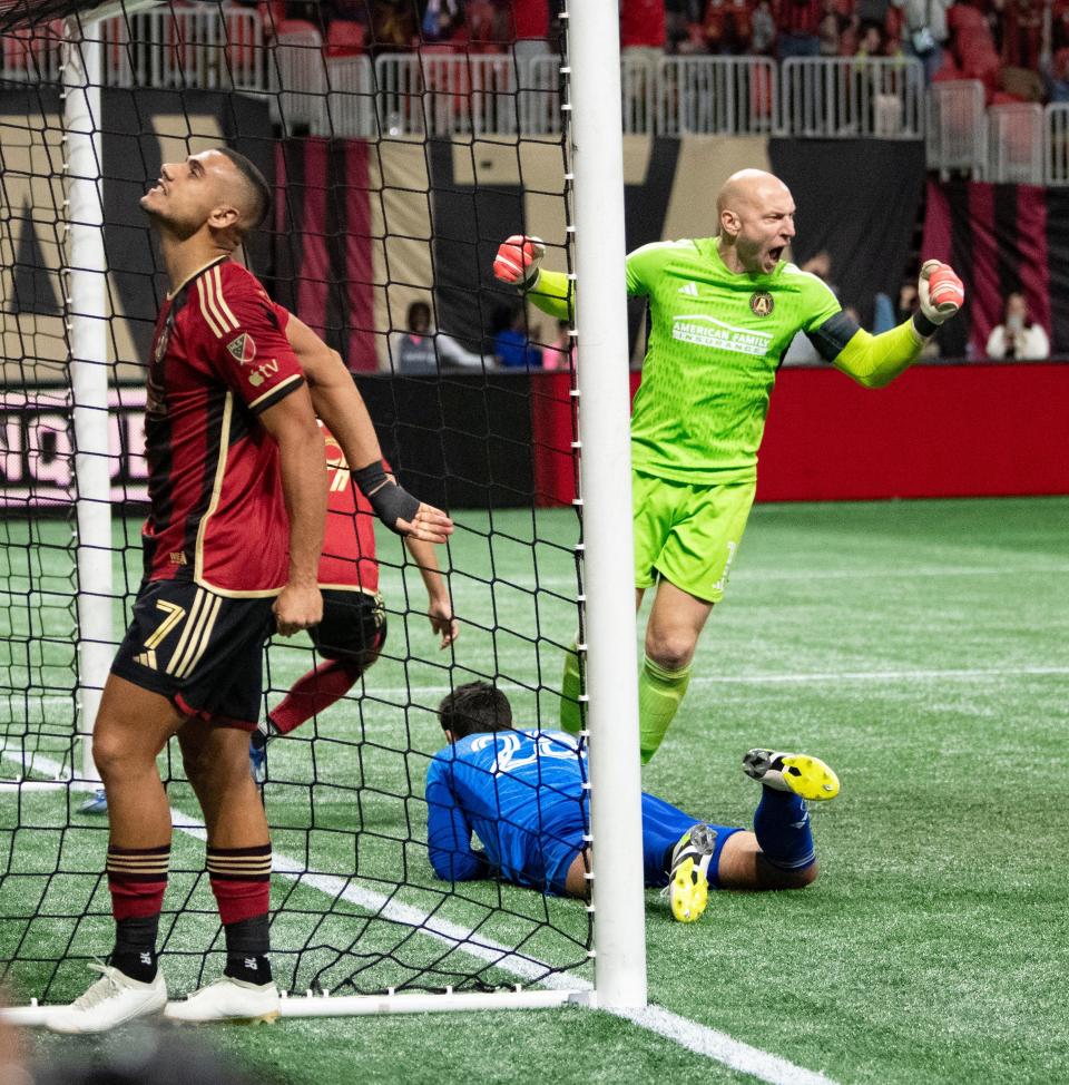 Atlanta forward Giorgos Giakoumakis (7) and goalkeeper Brad Guzan (1) celebrate after a goal by defender Miles Robinson to tie the Crew on Saturday.