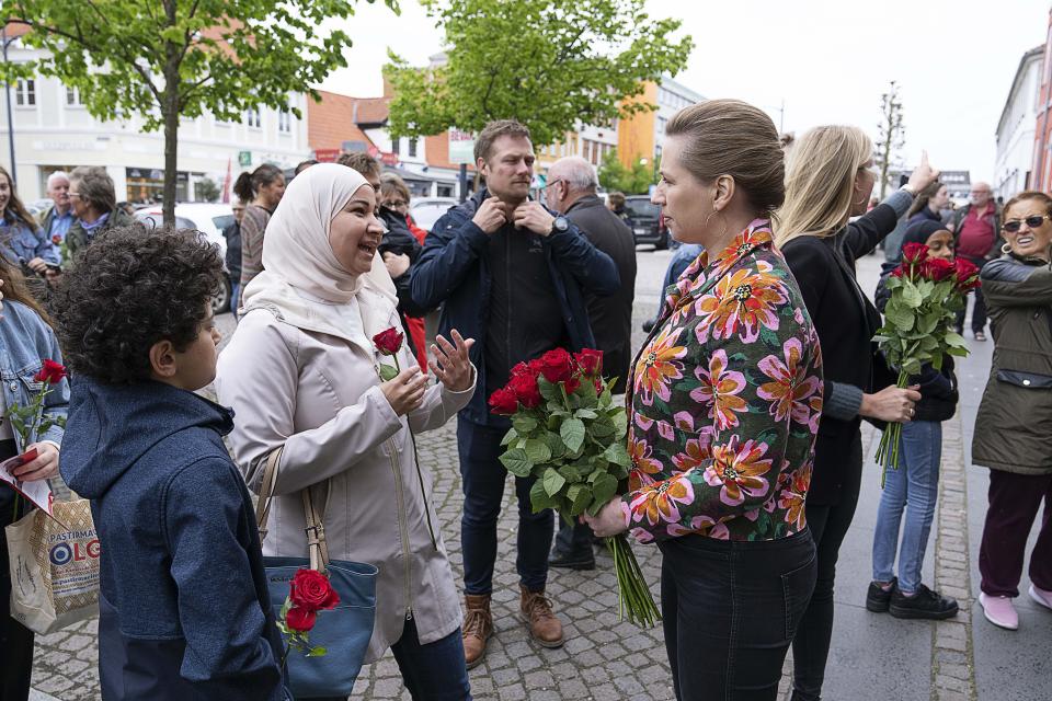 FILE - Denmark's Prime Minister Mette Frederiksen, right, speaks to people while on an election campaign, in Holbaek, Denmark, Saturday, May 28, 2022. Historically skeptical about European Union efforts to deepen security cooperation, Danish voters on Wednesday June 1, 2022, will decide whether to abandon their country's 30-year-old opt-out from the bloc's common defense policy. (Claus Bech/ Ritzau Scanpix via AP, File)