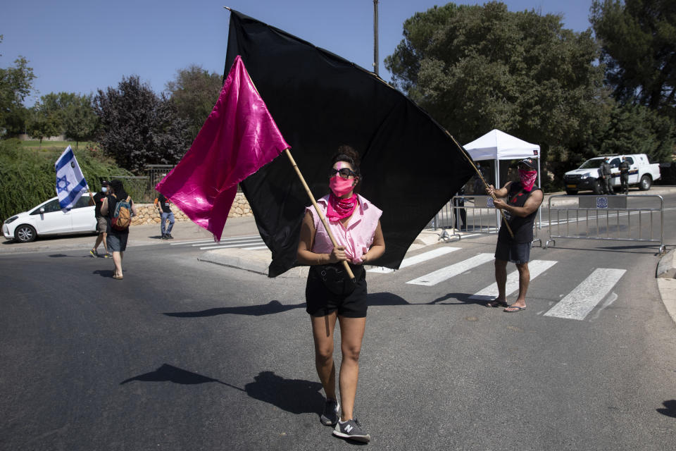 People demonstrate against a proposed measure to curtail public demonstrations during the current nationwide lockdown due to the coronavirus pandemic, in front of the Knesset, Israel's parliament in Jerusalem, Tuesday, Sept. 29, 2020. (AP Photo/Sebastian Scheiner)