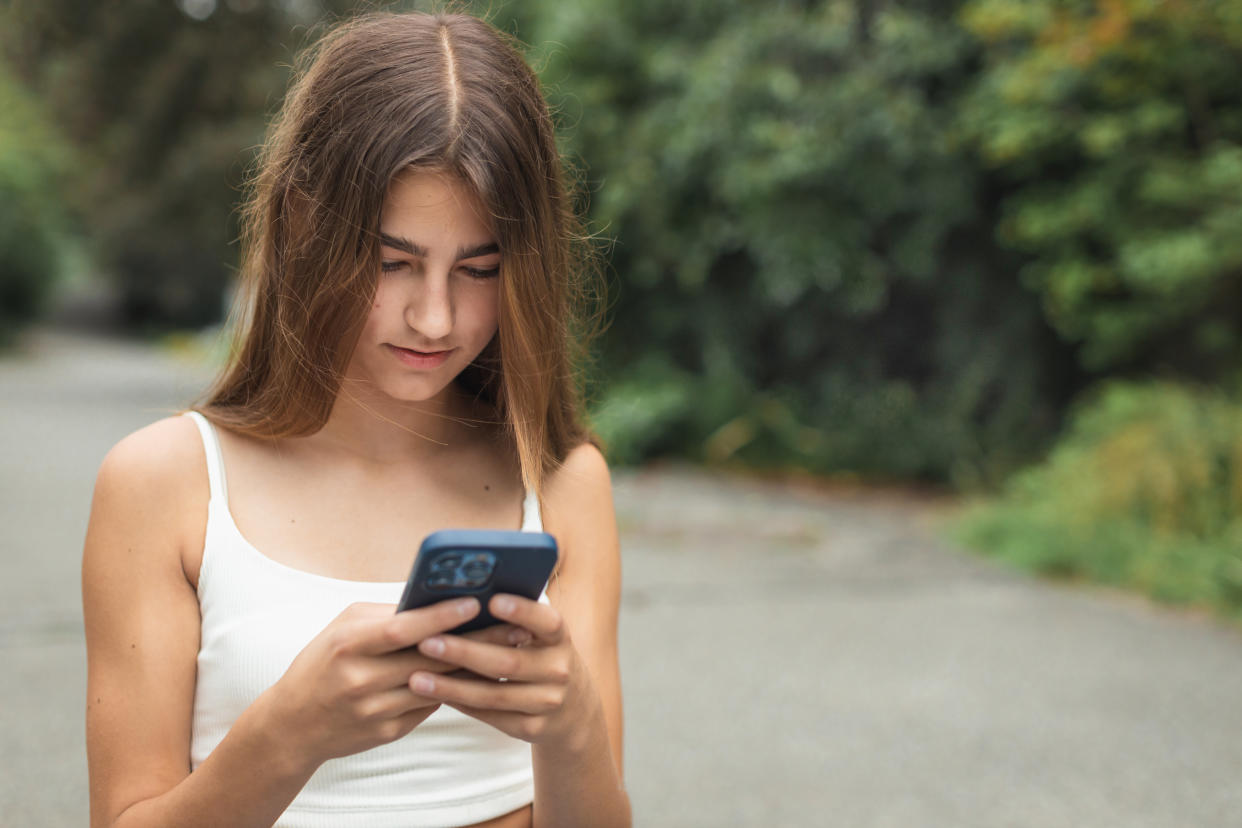 Teenage girl on her mobile phone. (Getty Images)