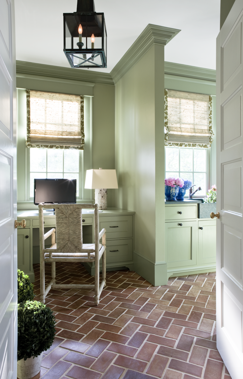 <p>Another good choice for brick? Green. In this office by Cavin-Winfrey, <a href="https://www.benjaminmoore.com/en-us/color-overview/find-your-color/color/495/hillside-green?color=495" rel="nofollow noopener" target="_blank" data-ylk="slk:Hillside Green;elm:context_link;itc:0;sec:content-canvas" class="link ">Hillside Green</a> was used on the walls and <a href="https://www.benjaminmoore.com/en-us/color-overview/find-your-color/color/482/misted-fern?color=482" rel="nofollow noopener" target="_blank" data-ylk="slk:Misted Fern;elm:context_link;itc:0;sec:content-canvas" class="link ">Misted Fern</a> on the trim and cabinets (both by Benjamin Moore).</p>