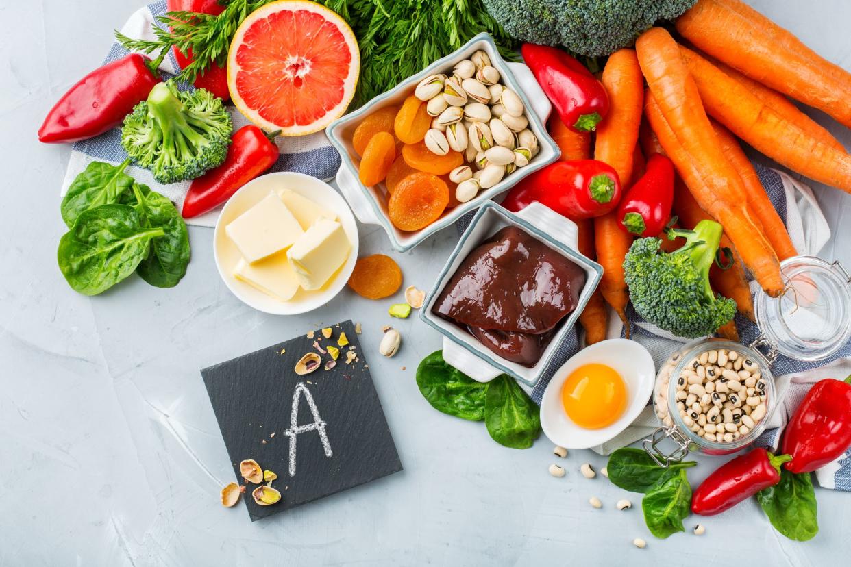 Balanced diet nutrition, healthy clean eating concept. Assortment of food sources rich in vitamin a on a kitchen table. Copy space background