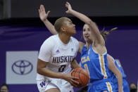 Washington center Quay Miller, left, tries to shoot past UCLA guard Chantel Horvat, right, during the first half of an NCAA college basketball game, Sunday, Feb. 7, 2021, in Seattle. (AP Photo/Ted S. Warren)