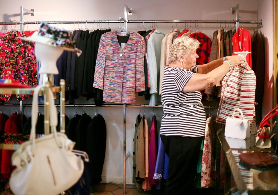 Volunteer Erika Kirk of Palm Beach tidies up at The Church Mouse in June 2010 ahead of the thrift shop's annual end-of-season sale.