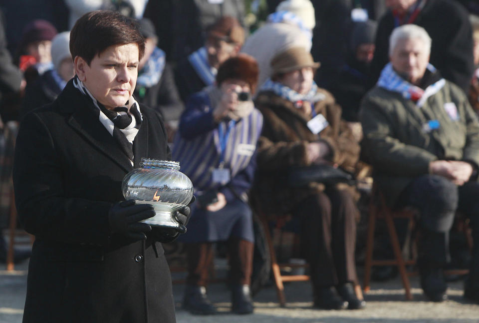 <p>Polish Prime Minister Beata Szydlo lights a candle at the International Monument to the Victims of Fascism, after a ceremony marking the 72nd anniversary of the liberation of the German Nazi death camp Auschwitz-Birkenau, in Oswiecim, Poland, Friday, Jan. 27, 2017, on the International Holocaust Remembrance Day. (Photo: Czarek Sokolowski/AP) </p>