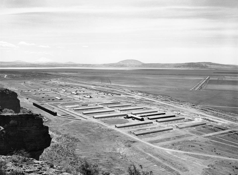 FILE - This May 23, 1943 file photo shows a Japanese relocation camp in Tule Lake, Calif. Tule Lake is at left, under Mount Shasta. Roughly 120,000 Japanese immigrants and Japanese-Americans were sent to desolate camps that dotted the West because the government claimed they might plot against the U.S. Thousands were elderly, disabled, children or infants too young to know the meaning of treason. Two-thirds were citizens. (AP Photo, File)