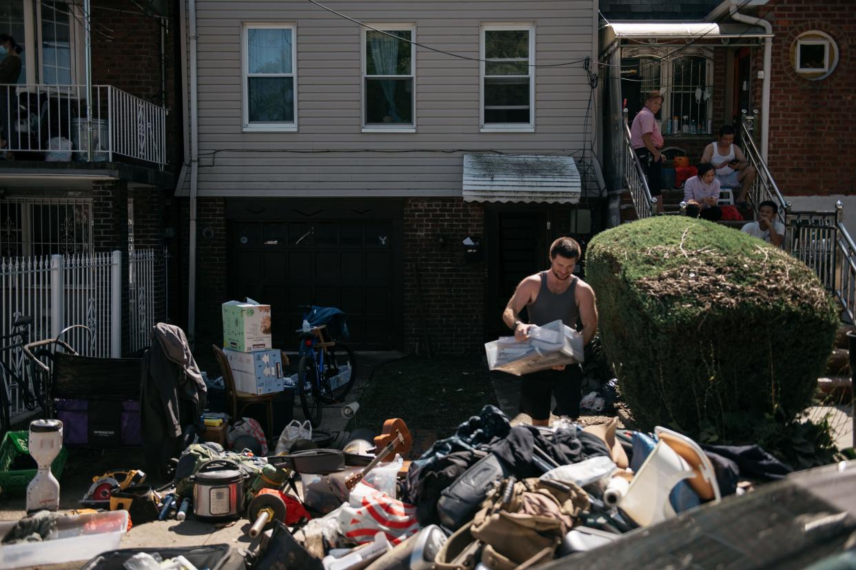 Residents sort through damaged and destroyed items after a night of heavy rain and wind caused many homes to flood on Sept. 2, 2021 in the Flushing neighborhood of the Queens borough of New York City.