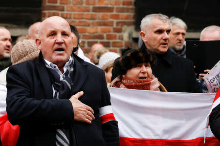 Piotr Rybak of the Polish independence movement and other far right activists pay tribute to Polish victims at the "death wall", during the ceremonies marking the 74th anniversary of the liberation of the camp and International Holocaust Victims Remembrance Day, in Oswiecim, Poland, January 27, 2019. REUTERS/Kacper Pempel