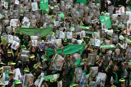 Supporters of then Iranian presidential candidate Mir Hossein Mousavi wave green flags - his campaign colour - at a pro-reform rally in Tehran on June 9, 2009