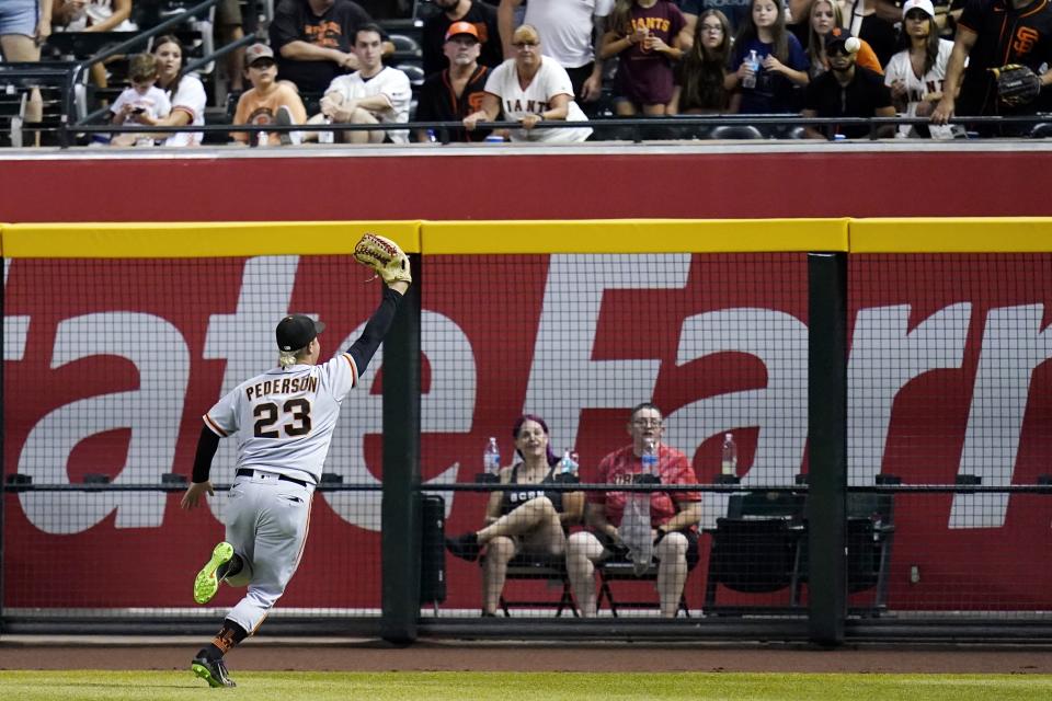 San Francisco Giants right fielder Joc Pederson is unable to make a play on a double hit by Arizona Diamondbacks' Carson Kelly during the fifth inning of a baseball game Tuesday, July 5, 2022, in Phoenix. (AP Photo/Ross D. Franklin)