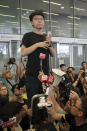 Pro-democracy activist Joshua Wong speaks to protesters near the Legislative Council following a massive protest against the unpopular extradition bill in Hong Kong, Monday, June 17, 2019. Wong, was released from prison Monday after serving half of a two-month jail sentence for contempt. He headed to join protesters gathered near Hong Kong's government headquarters soon afterward, and also called in a tweet for Chief Executive Carrie Lam to resign and for a halt to "all political persecutions." (AP Photo/Kin Cheung)