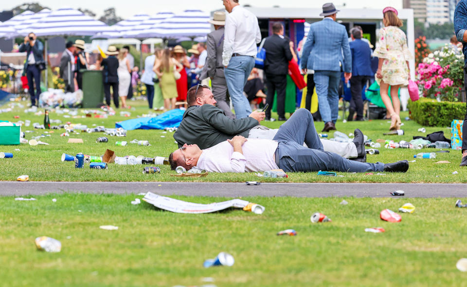 Racegoers, pictured here laying down on the lawn.