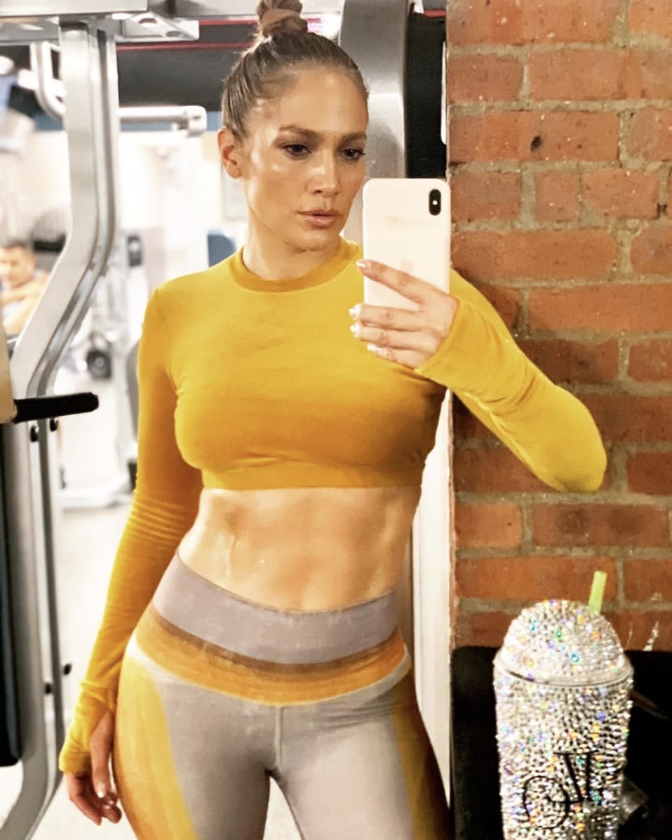 Jennifer Lopez flaunts her toned abs after a "sweaty SoLful Sunday" at the gym while showing off new pieces from the fall collection of Niyama Sol workout gear.
