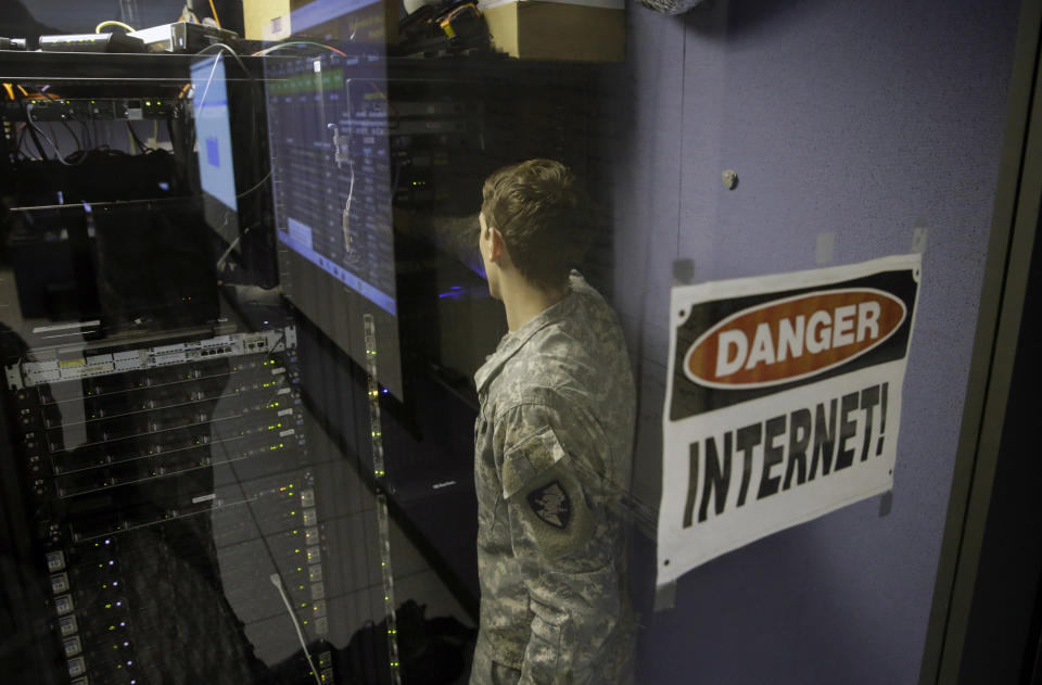 A United States Military Academy cadet checks computers at the Cyber Research Center at the United States Military Academy in West Point, N.Y., Wednesday, April 9, 2014. The West Point cadets are fending off cyber attacks this week as part of an exercise involving all the service academies. The annual Cyber Defense Exercise requires teams from the five service academies to create computer networks that can withstand attacks from the National Security Agency and the Department of Defense. (AP Photo/Mel Evans)