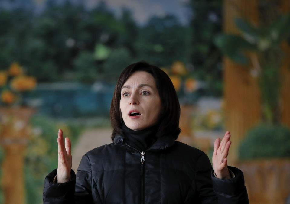 FILE - In this Friday, Feb. 22, 2019 file photo, Maia Sandu, leader of the ACUM opposition alliance, speaks to people during an electoral meeting in Loganesti, Moldova. A Moldovan court has appointed former prime minister Pavel Filip as interim president, a day after a new government was formed following a months-long political stalemate. The Constitutional Court said Sunday, June 9 that Igor Dodon, who supported the new government, was being relieved of his duties for failing to comply with its ruling to dissolve parliament. (AP Photo/Vadim Ghirda, File)