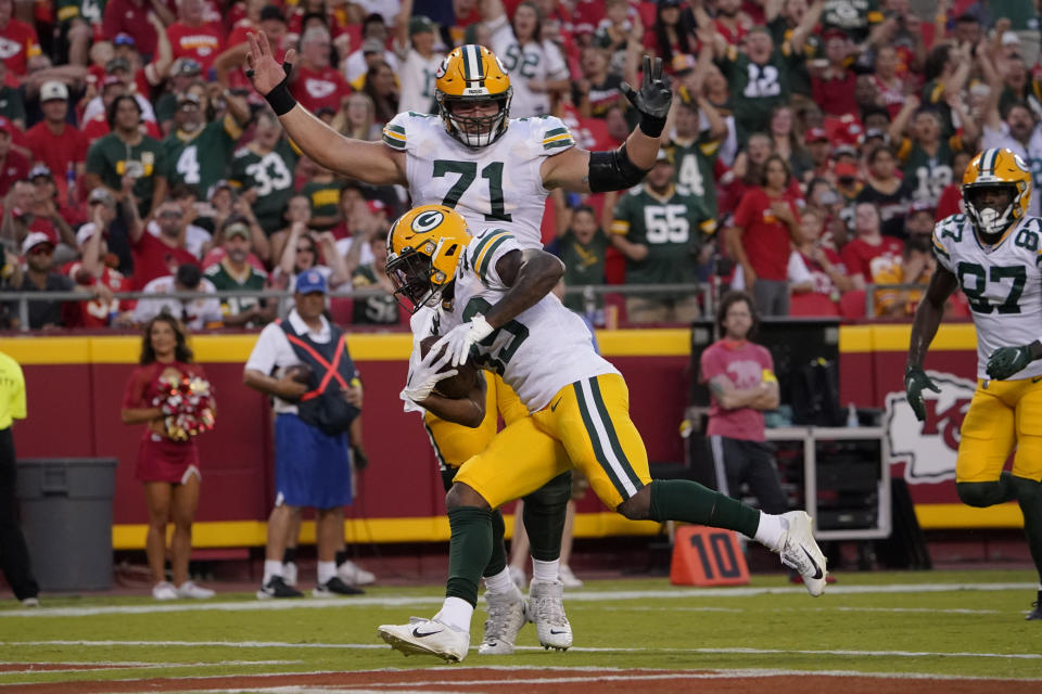 Green Bay Packers running back Tyler Goodson is congratulated by teammate center Josh Myers (71) after scoring a touchdown during the first half of an NFL preseason football game against the Kansas City Chiefs Thursday, Aug. 25, 2022, in Kansas City, Mo. (AP Photo/Ed Zurga)